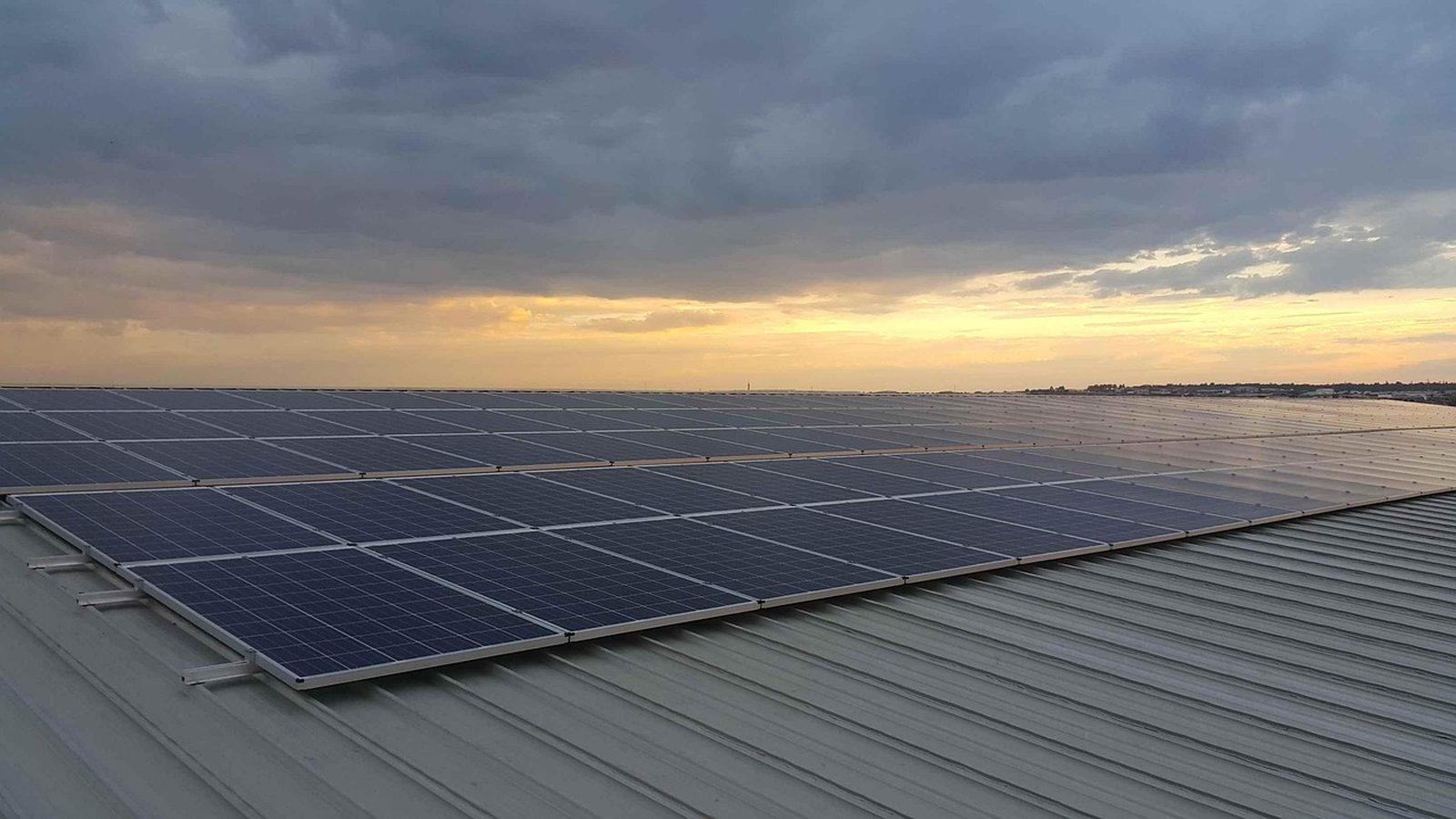 Solar panels on a standing seam metal roof at dusk