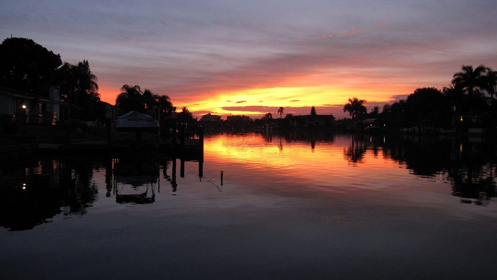 Sunset over a Cape Coral canal lined with waterfront homes