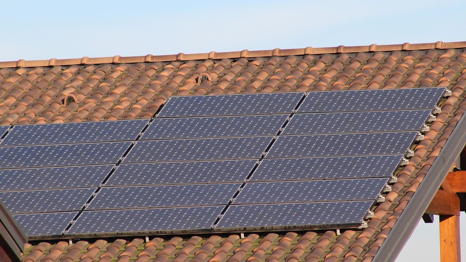 Photovoltaic array on a tile roof under clear sky