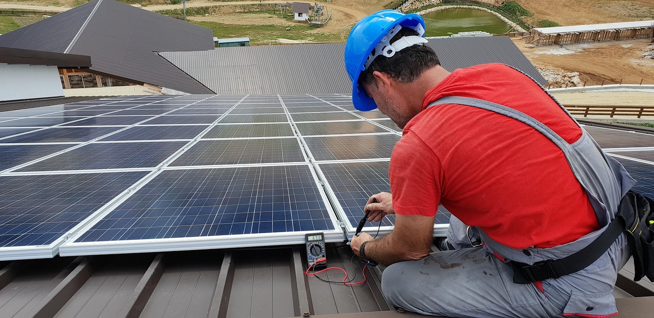 A technician installing solar panels in Escondido, California