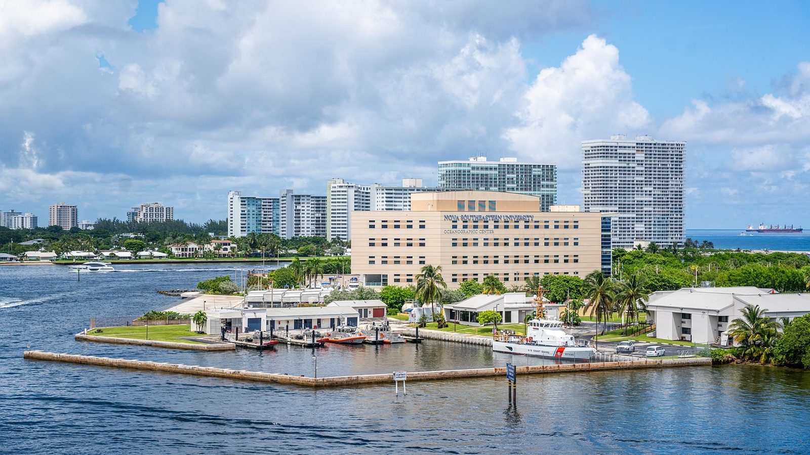 Fort Lauderdale waterfront buildings under a sky of scattered clouds