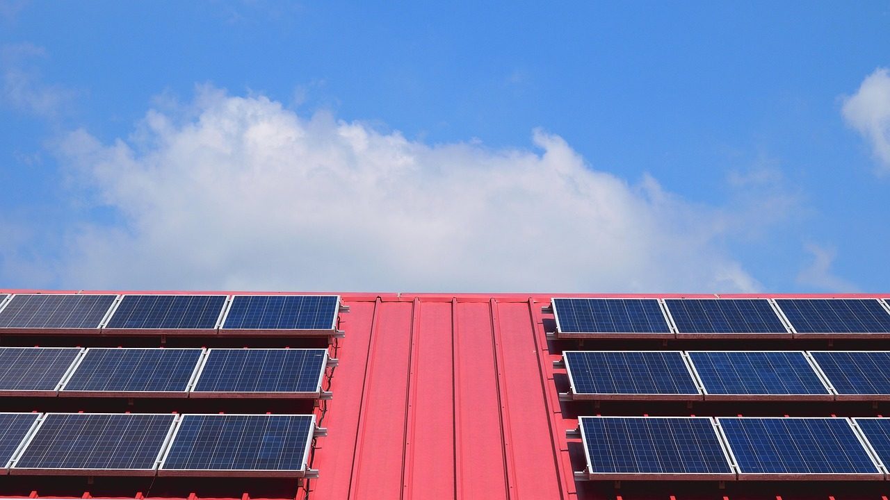 Rooftop solar panels under a blue sky