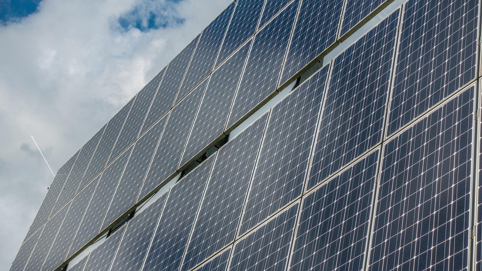 Photovoltaic panels under a partly cloudy sky