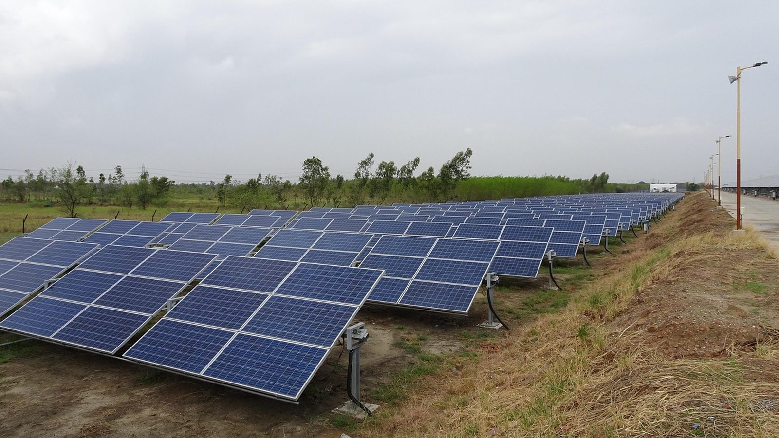 Rows of solar panels along a canal bank