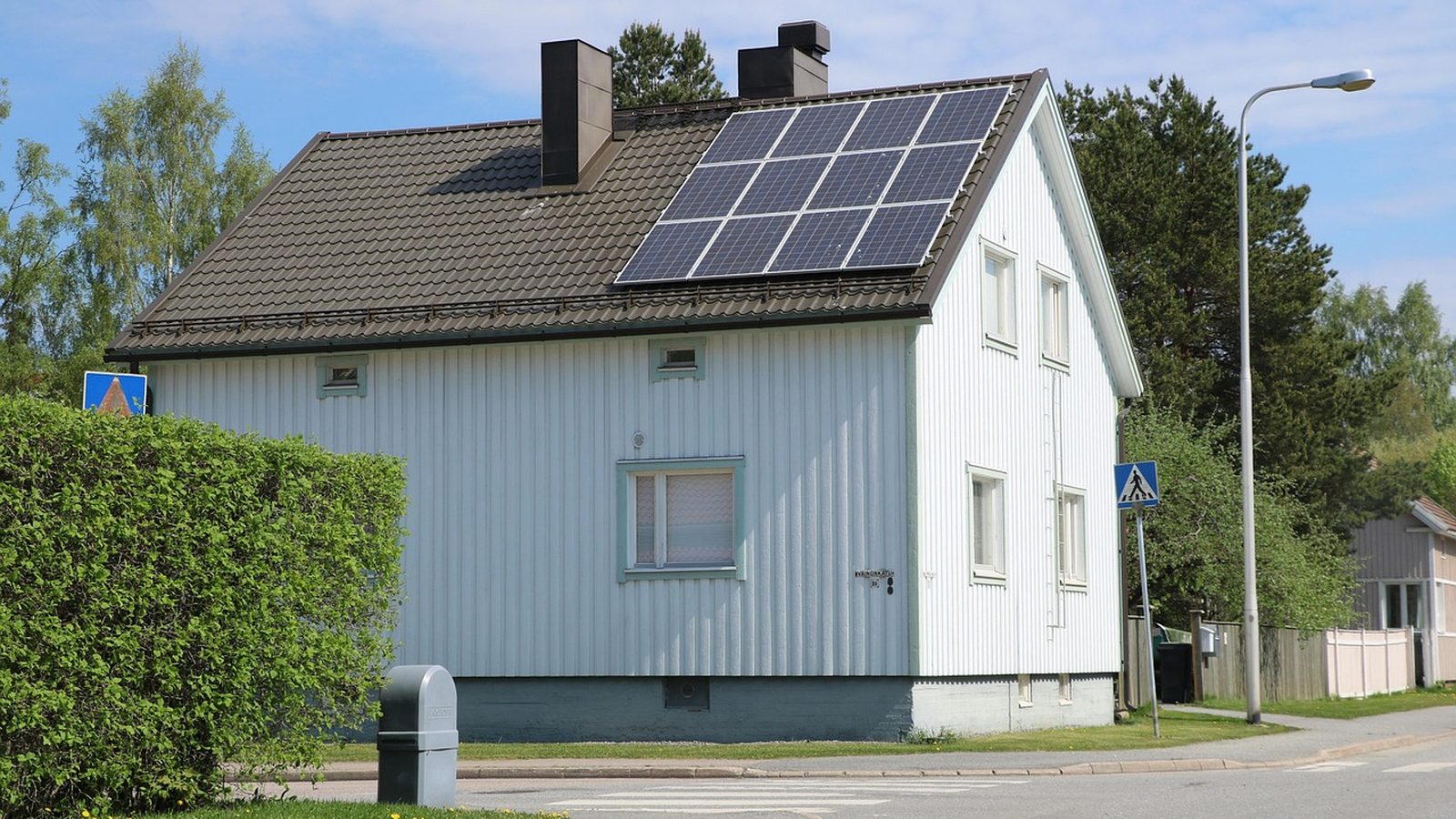 Detached house with solar panels mounted on its roof