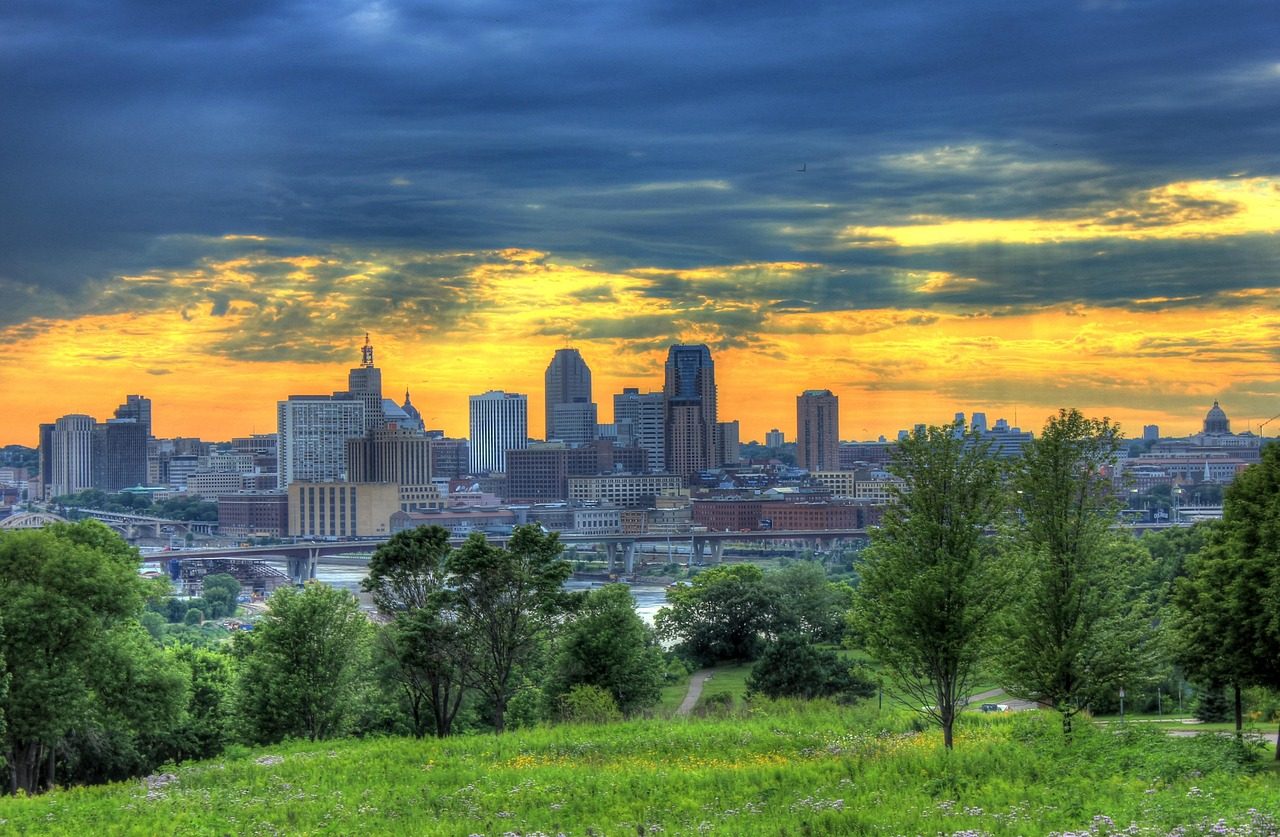 Minneapolis and St. Paul skyline at dusk with clouds