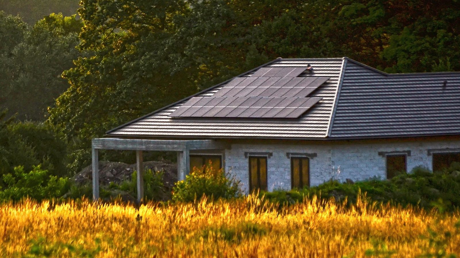 House with rooftop solar panels at dusk