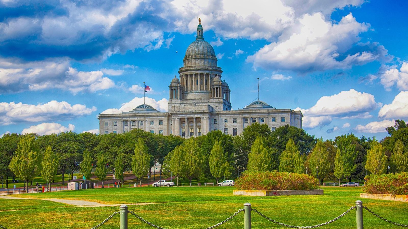 The Rhode Island State House dome above green lawns in Providence