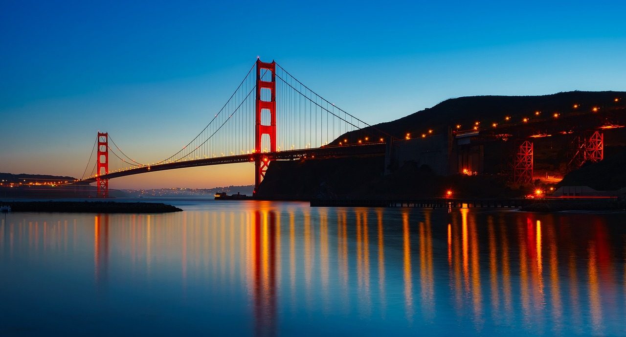 Golden Gate Bridge illuminated over San Francisco Bay at dusk