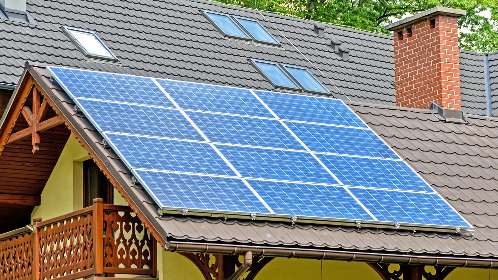 Solar panels mounted on a tile roof under a clear sky