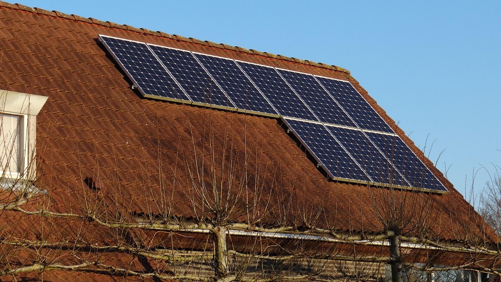Solar panels on a house roof in autumn light