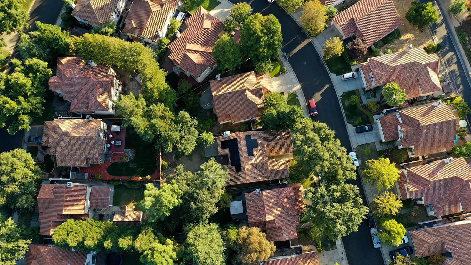 Aerial drone view of rooftop solar panels on suburban homes