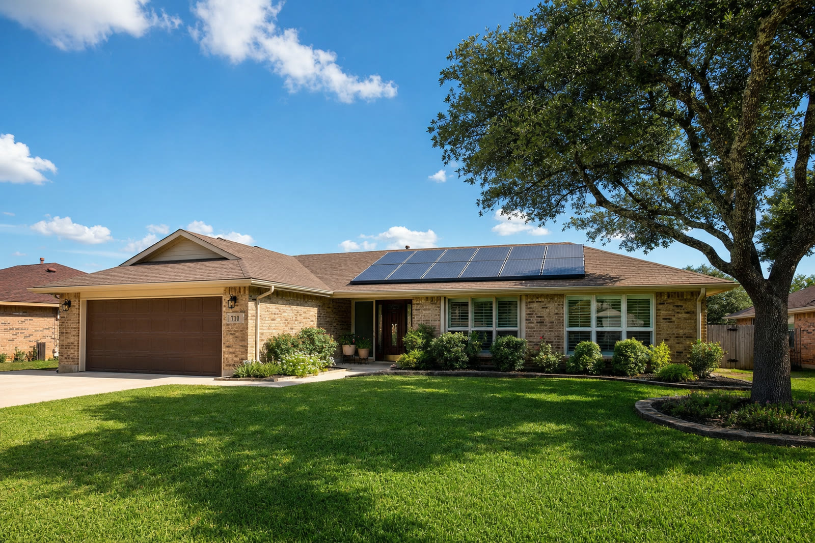 Single story brick Texas ranch home with a large rooftop solar array